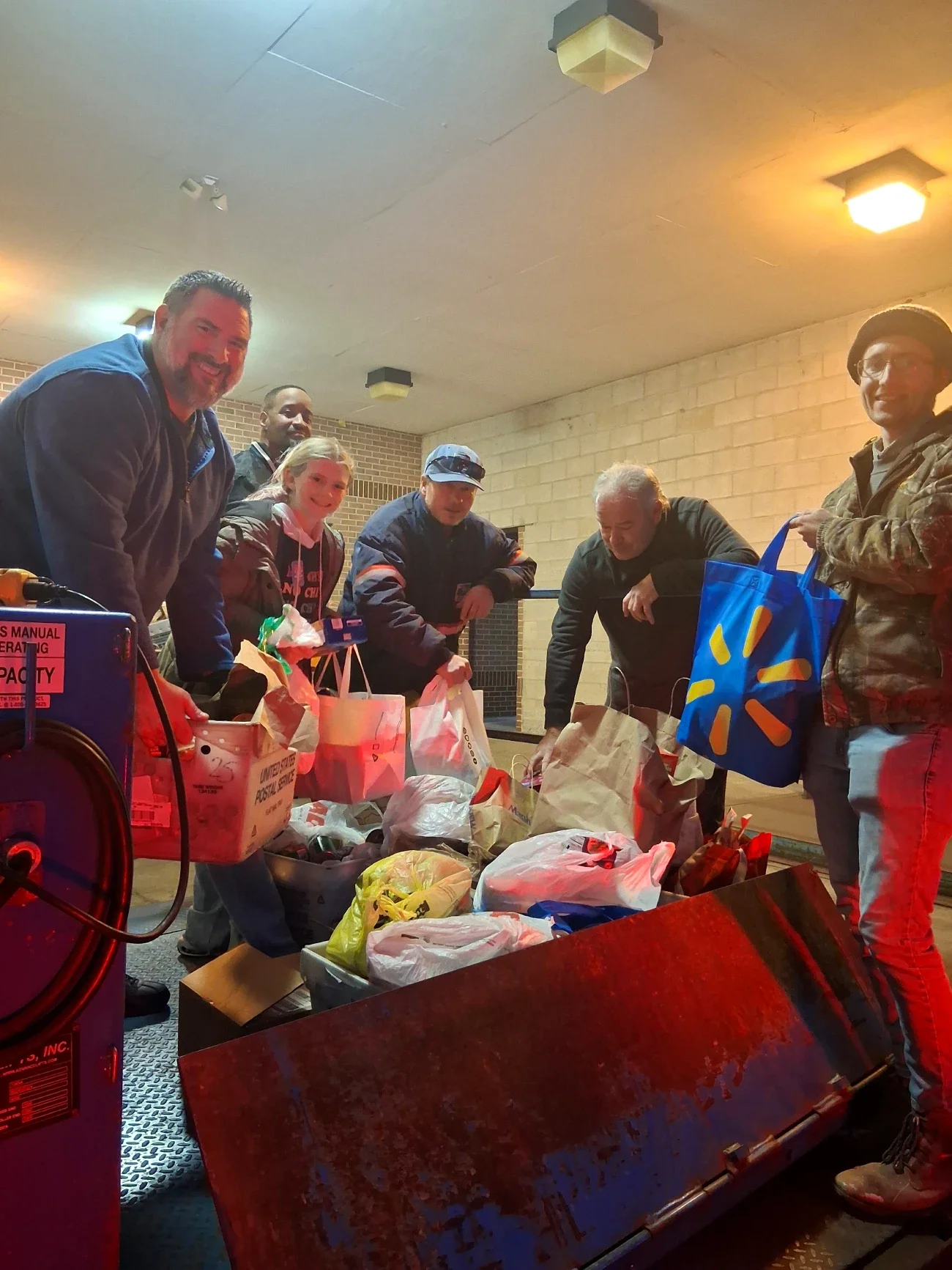 A group of people hands off bags of food