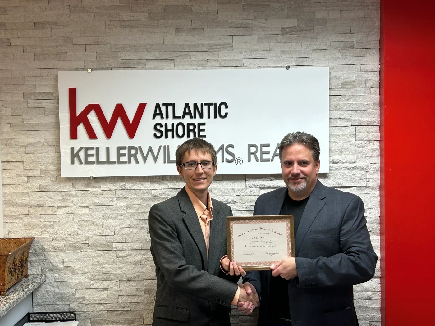 Two men shaking hands at Keller Williams Realty
