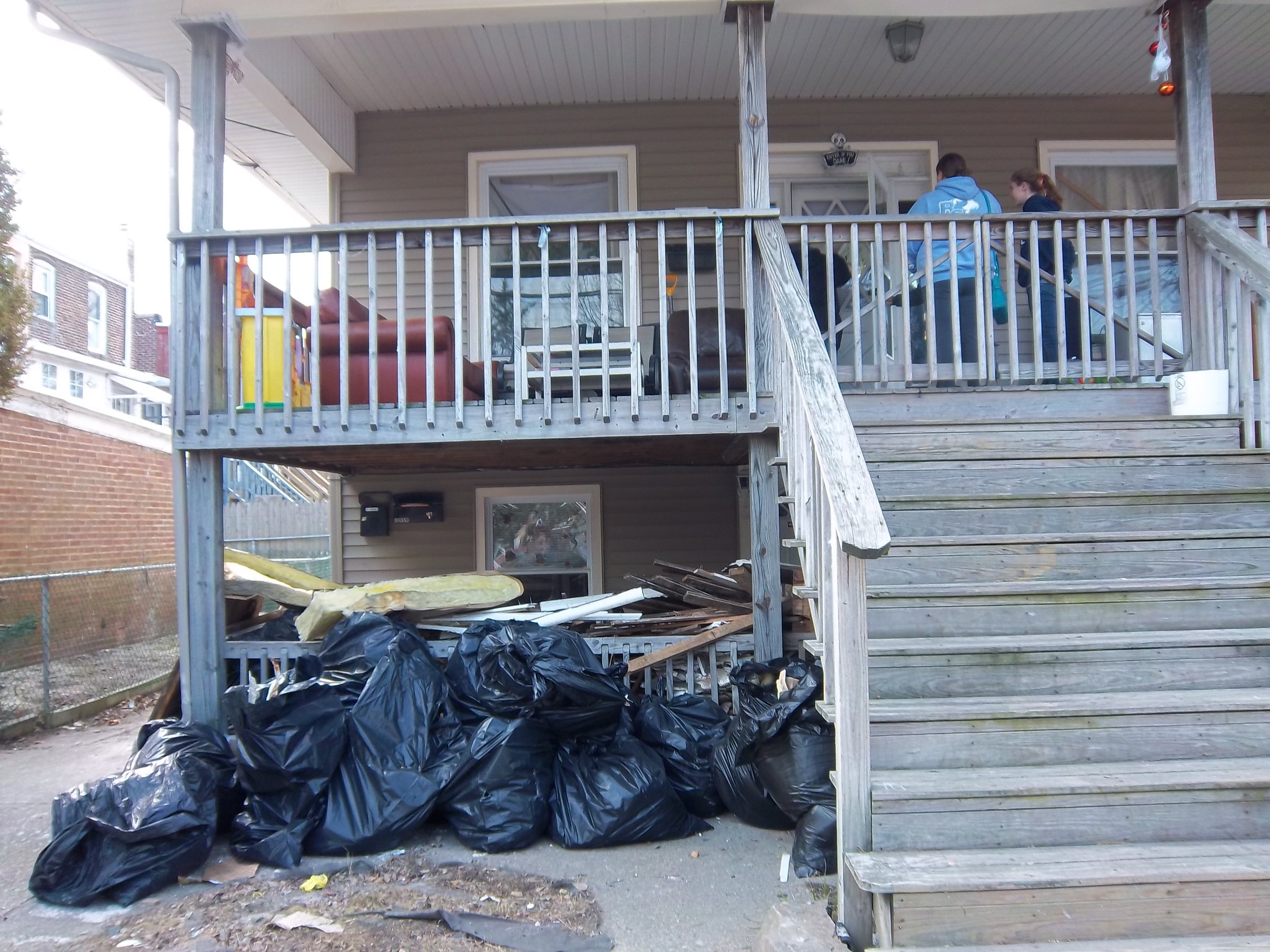 A pile of destroyed furniture beneath a home