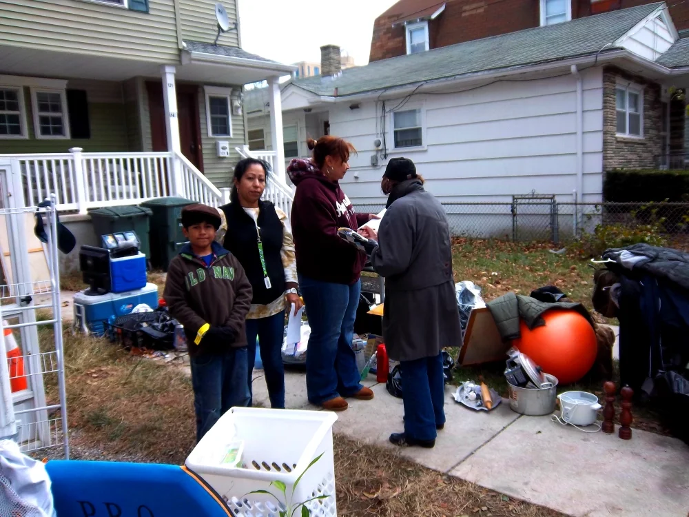 An ESWA volunteer signs up a new member outside their home