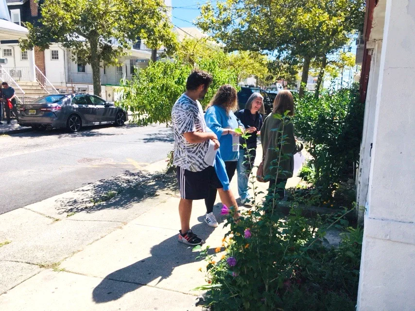 A group of volunteers walking along a sidewalk
