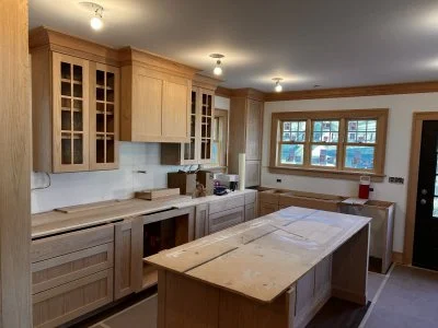 Minneapolis custom kitchen cabinets with unfinished wood and an island, large window, and door to the outside.