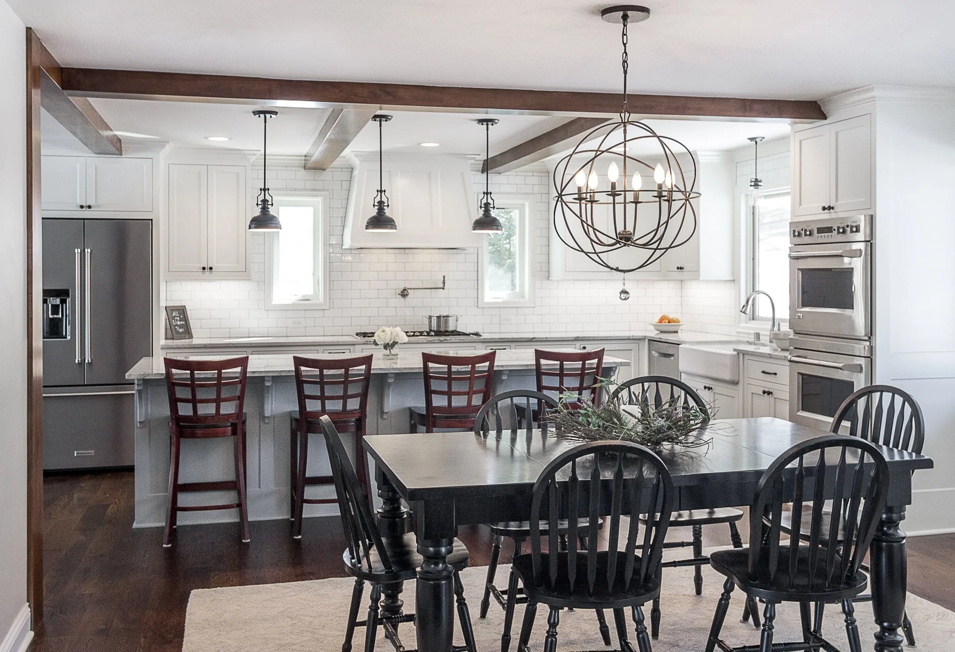 Edina custom kitchen remodel, white cabinets, quartzite countertops, rustic wooden beams, black pendant lights.
