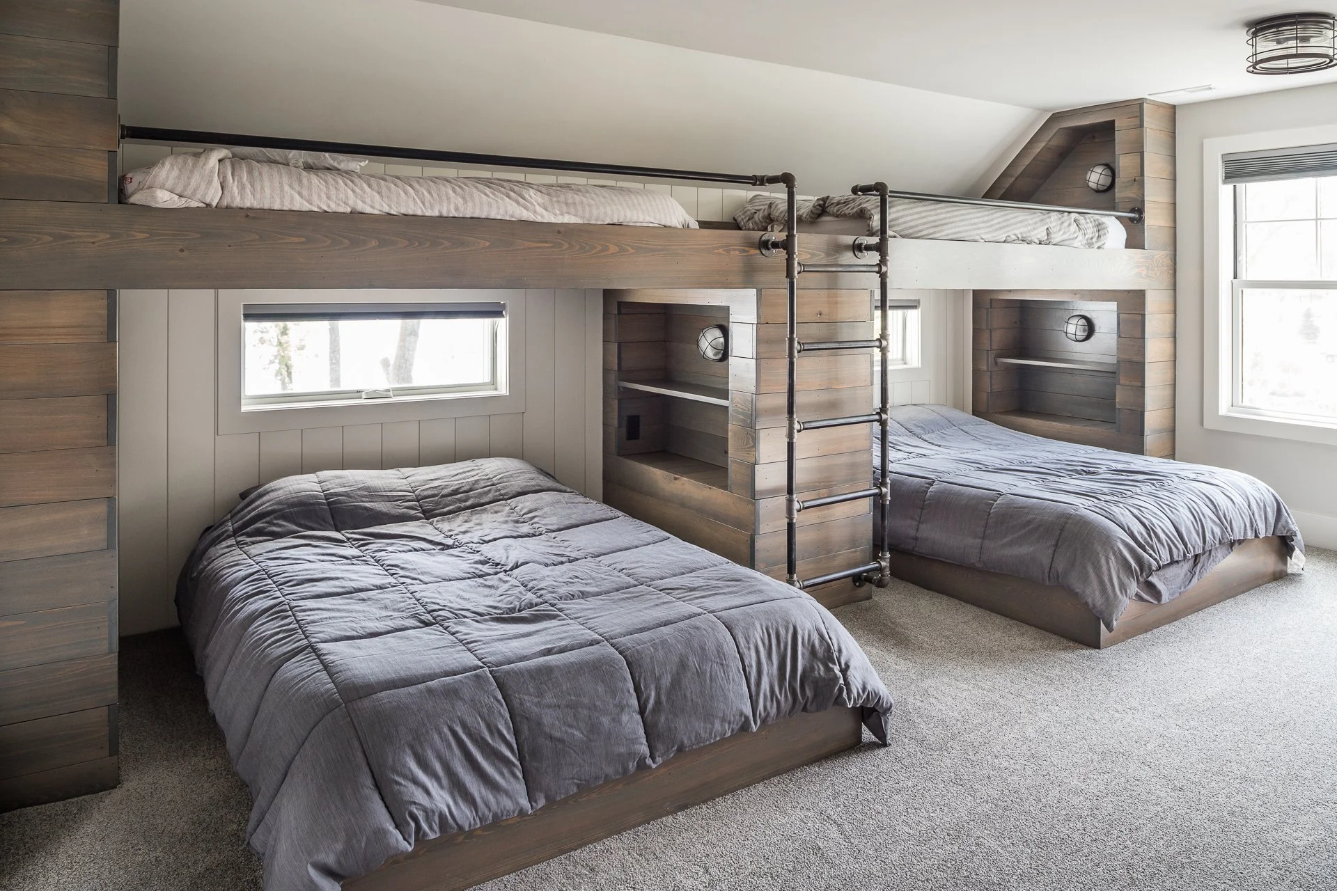 stained wood bunk beds, black pipe rails