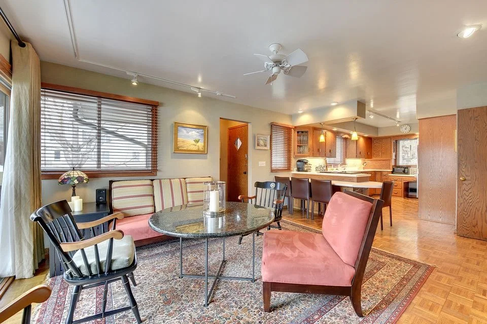 original Edina kitchen and sitting room, with dated wood cabinets.