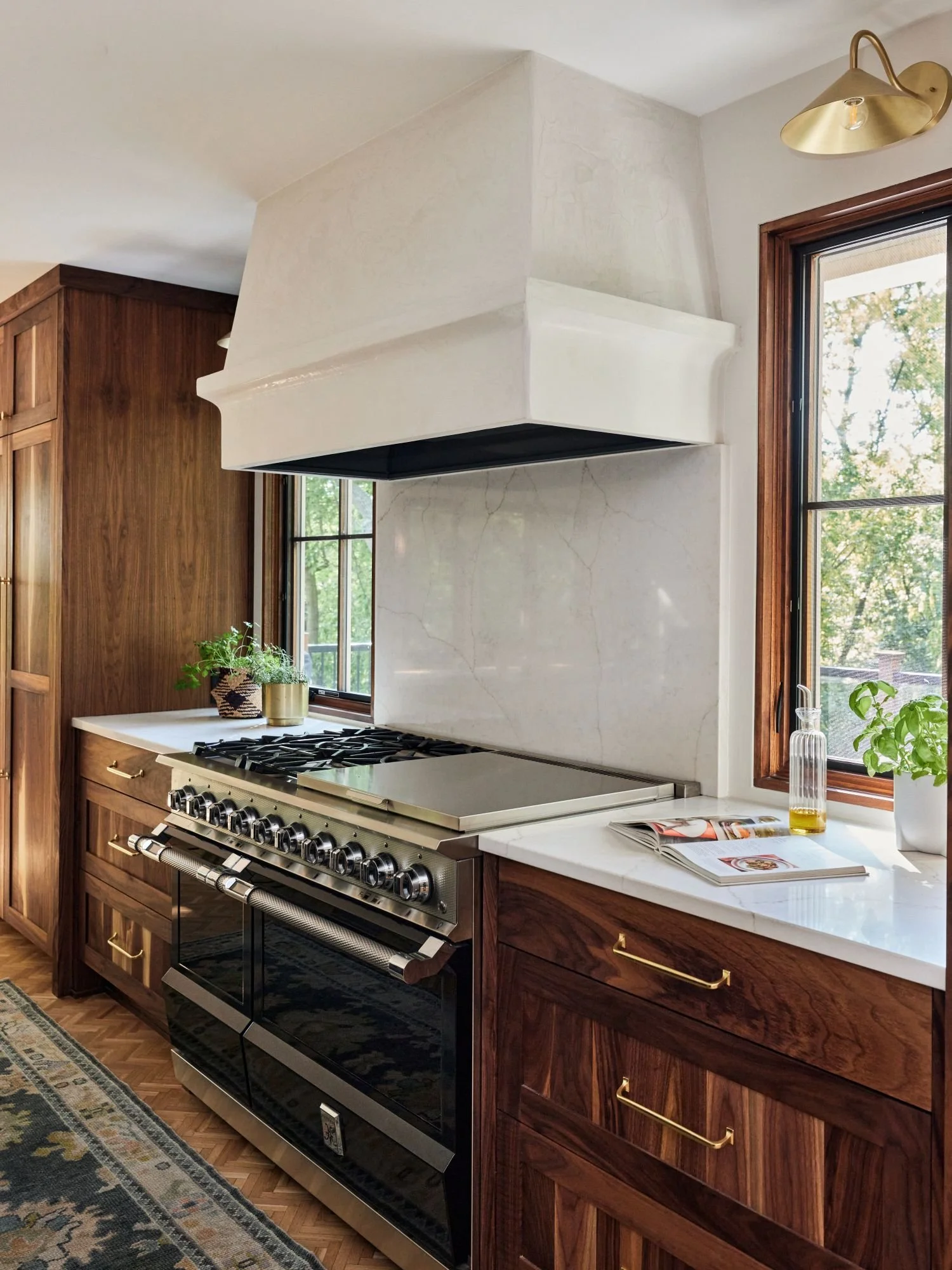 Golden Valley kitchen walnut and black stained oak cabinets, quartz  countertops, butcherblock countertop, parquet flooring, plaster hood.