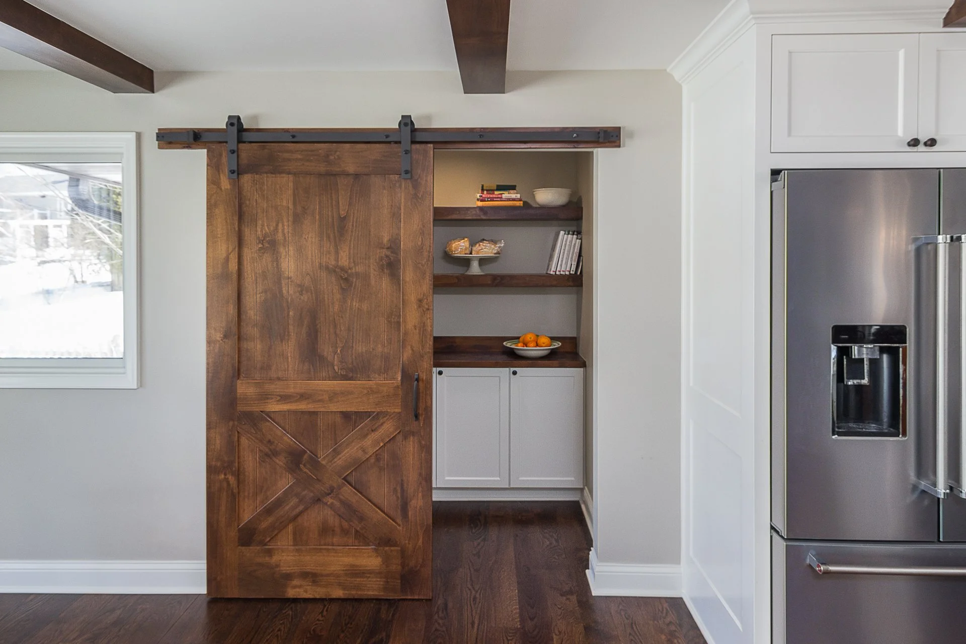 Pantry with stained wood barn door