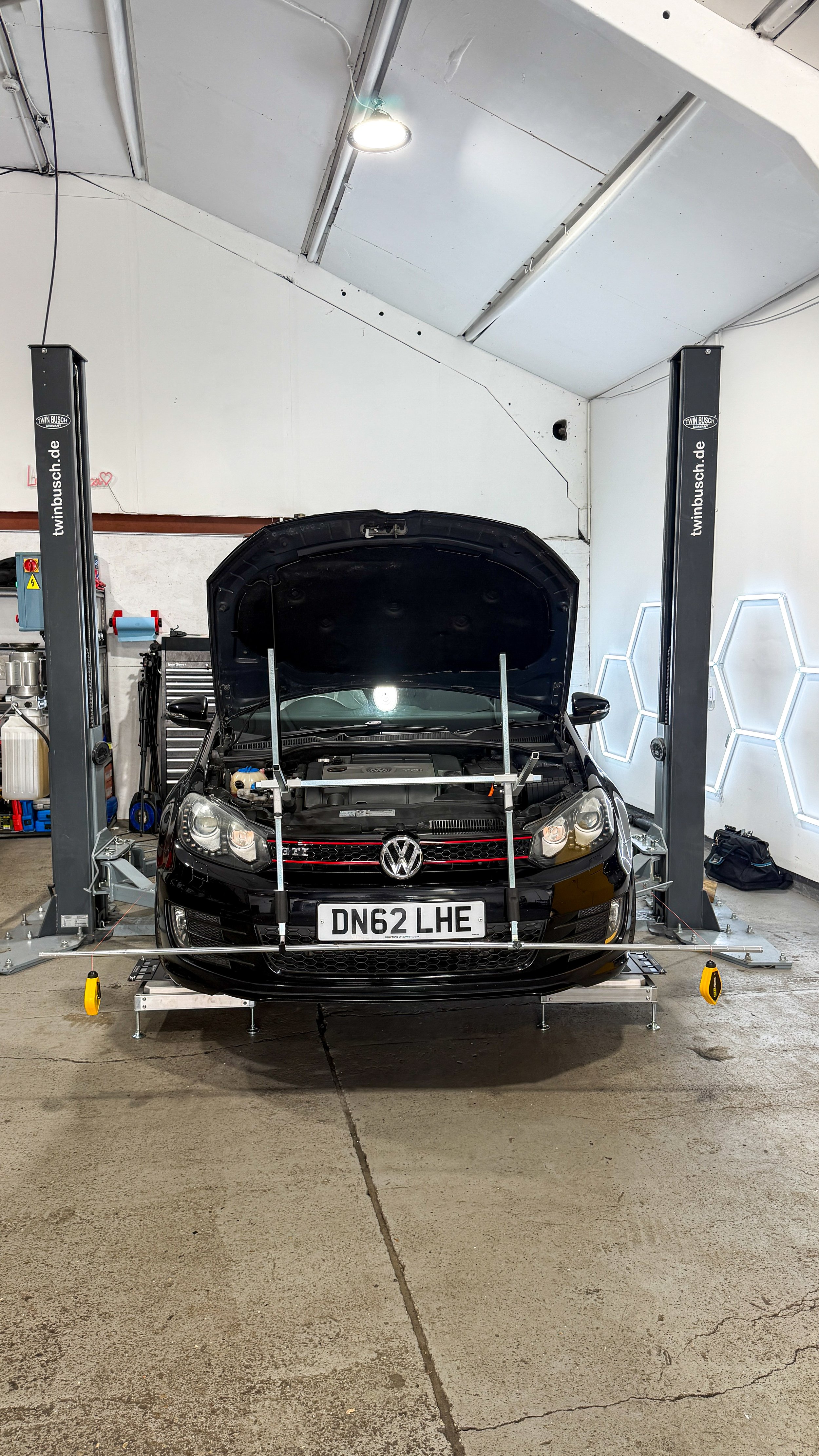 Volkswagen GTI fast road car undergoing four-wheel string alignment