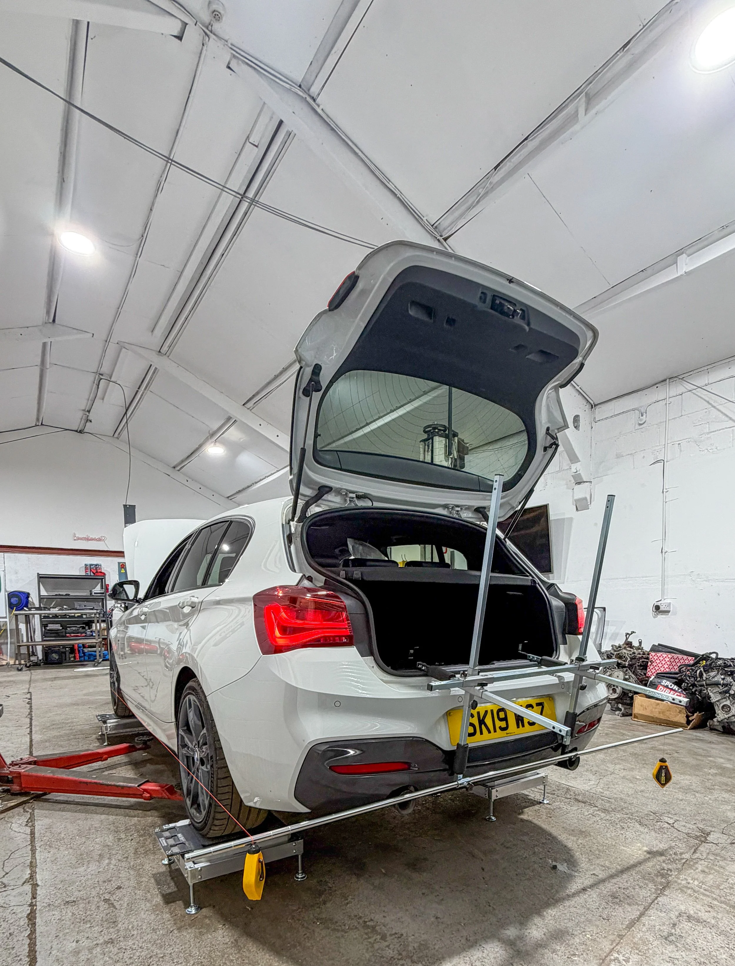 BMW M140I undergoing corner weighting and four-wheel string alignment