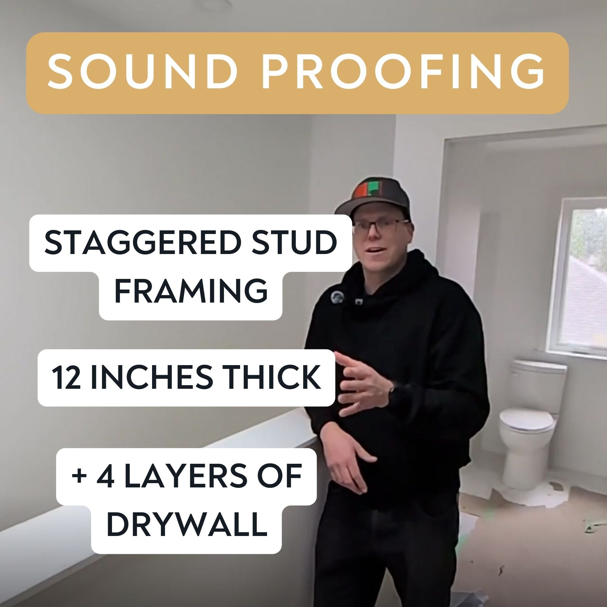 Person wearing glasses and a baseball cap standing in a room with light gray walls and white trim, with a window and a toilet visible in the background. There are text overlays about soundproofing and drywall layers.