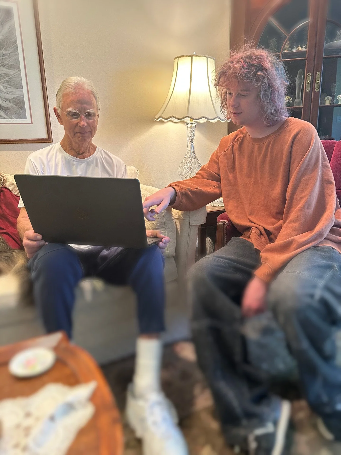 Skip helping a person on the left who is holding a laptop