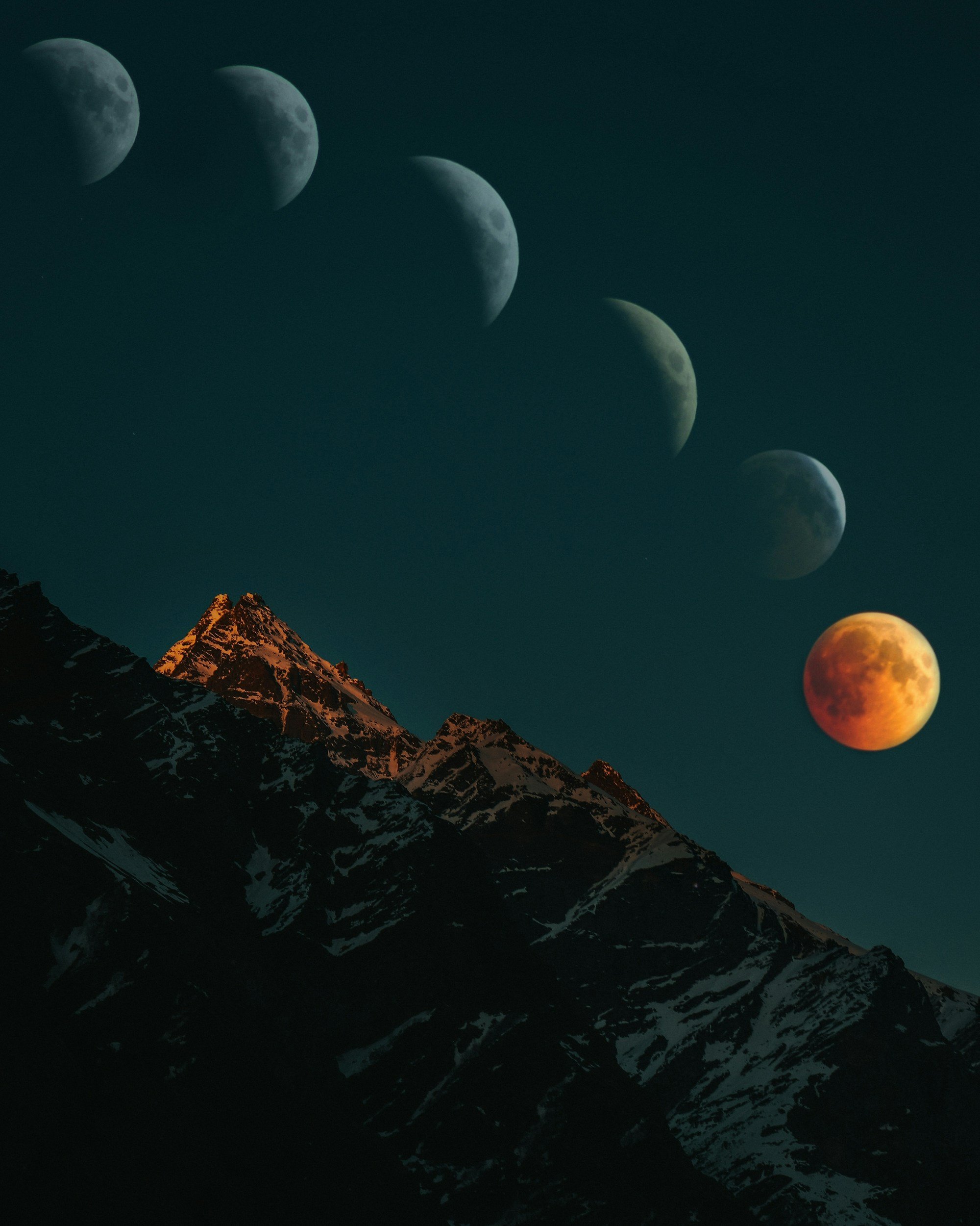 Sequence of moon phases over snow-capped mountain peaks at night.