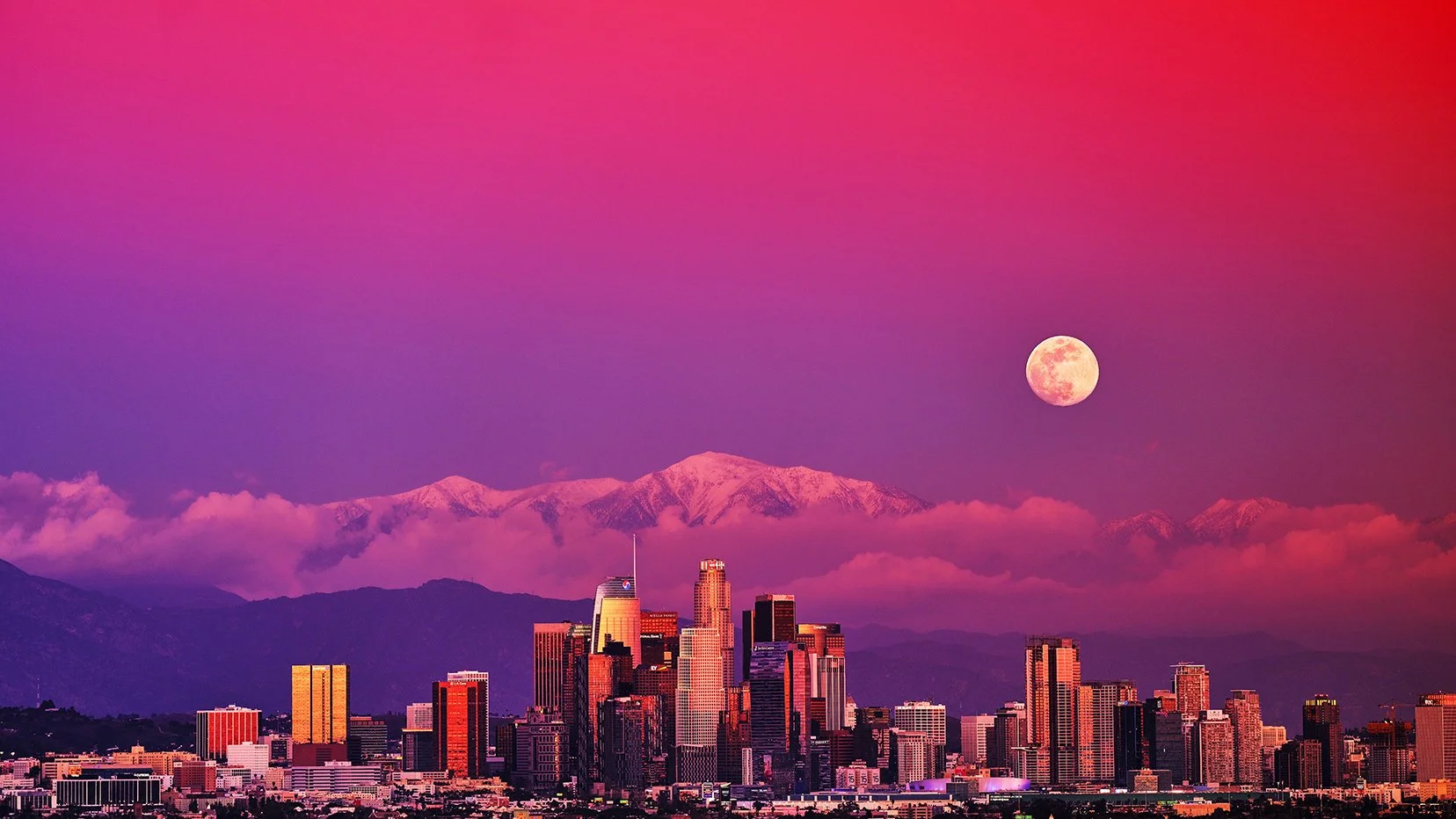 City skyline of Los Angeles with snow-capped mountains in the background and a full moon in a pink and purple sky.