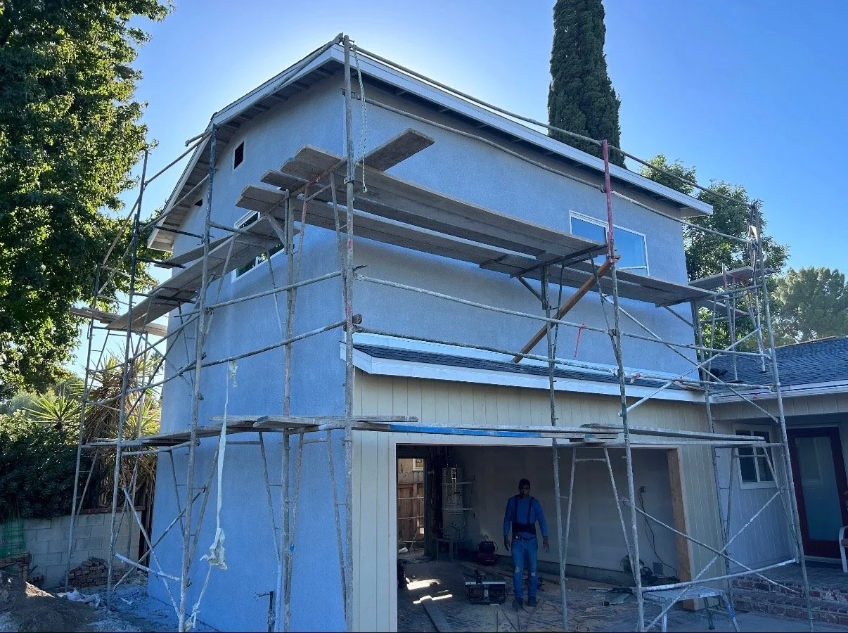 Garage conversion with second story addition during residential construction project.