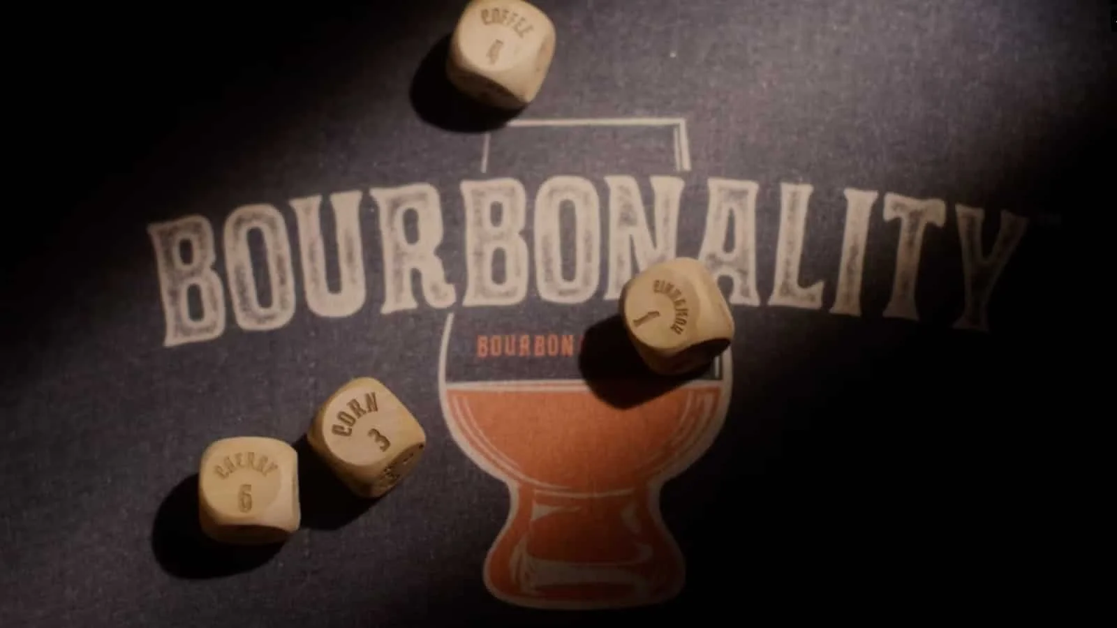 Four wooden dice with brewery-related words and numbers on a dark surface with a 'Bourbonality' graphic and text.