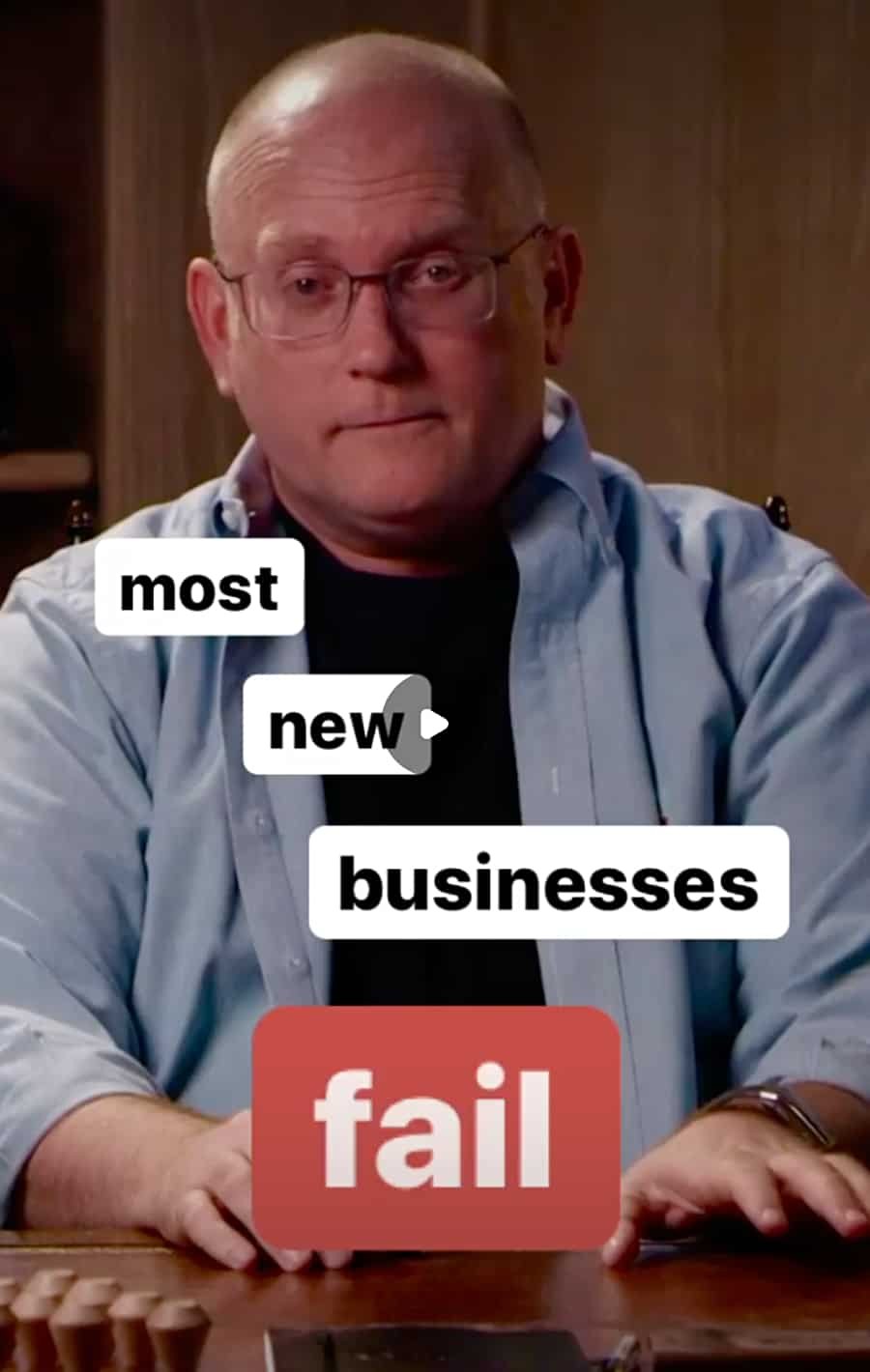 A man with glasses and a blue shirt sitting at a table with a serious expression. There are words overlaid on the image: "most," "new," "businesses," and a red box with the word "fail."