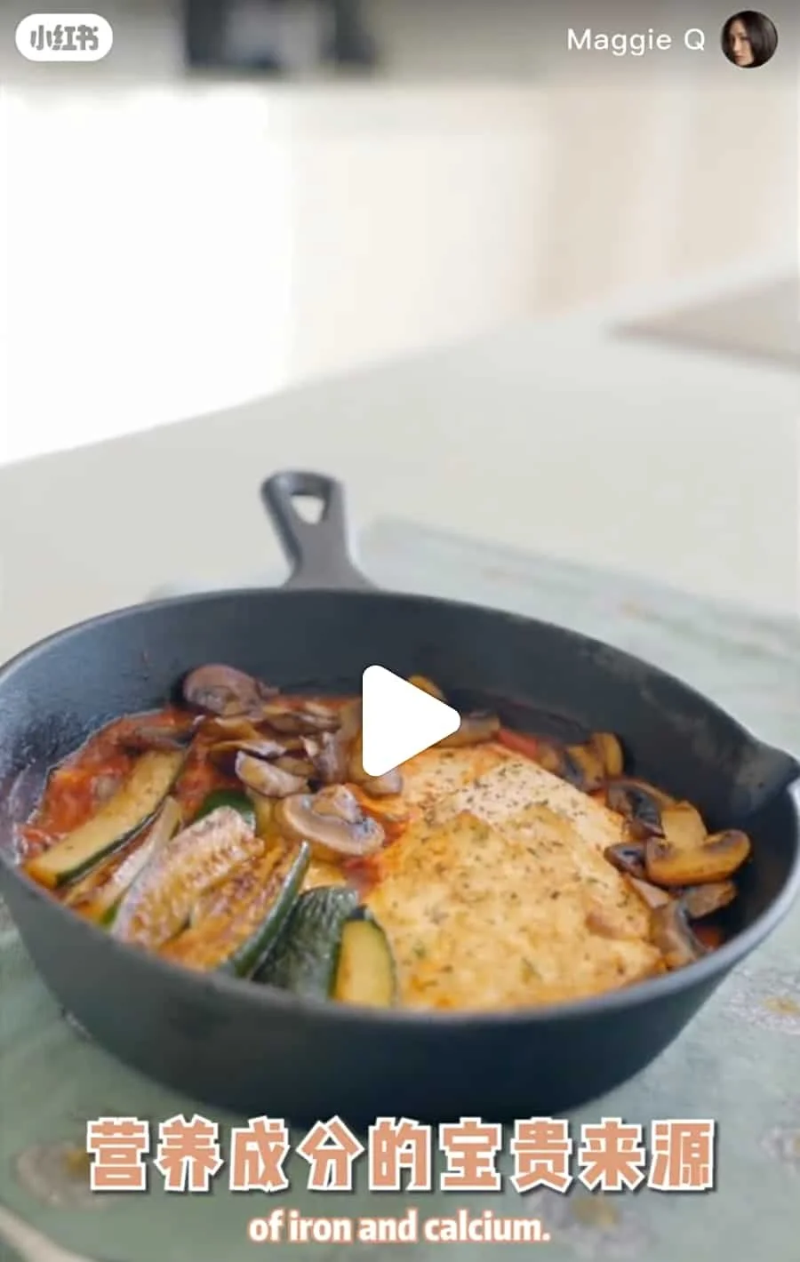A skillet containing zucchini slices, mushrooms, and tomato sauce.