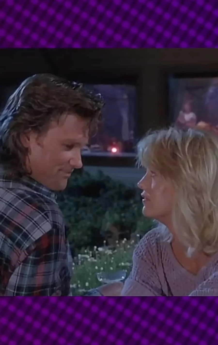 A scene from a movie featuring a man and woman sitting closely, gazing into each other's eyes at night.