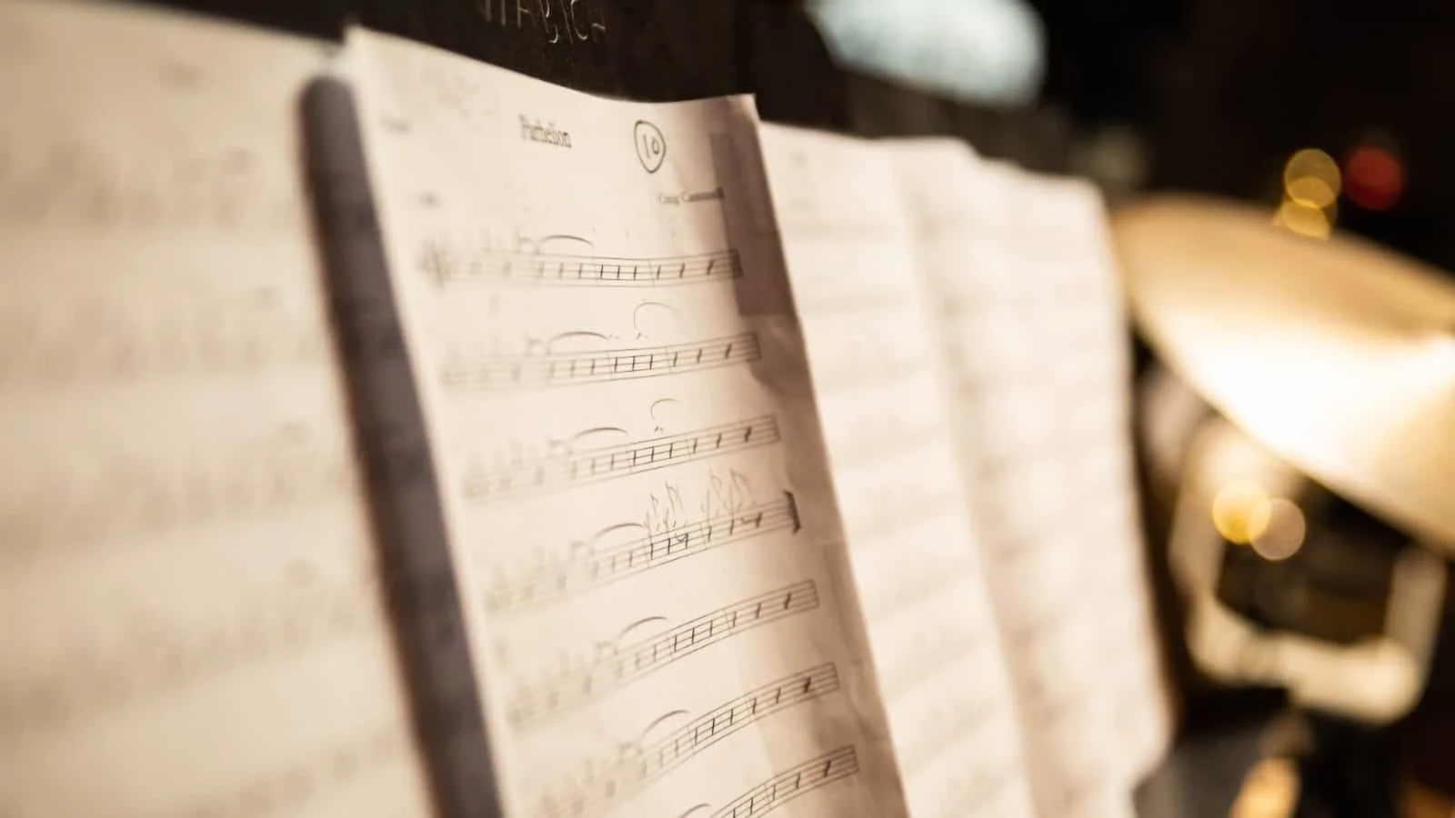 Close-up of sheet music on a music stand on a piano.