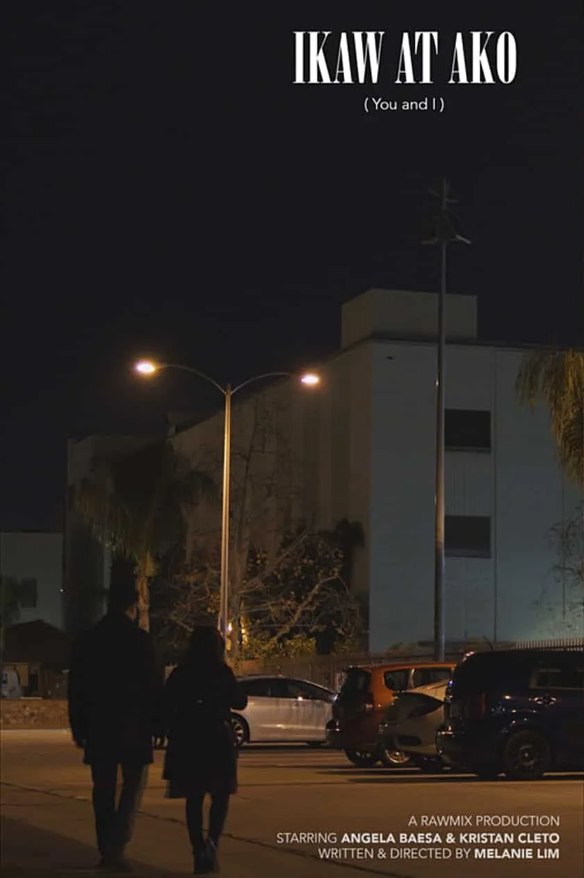 Nighttime scene in a parking lot with two people walking. Overhead streetlights illuminate the area. Text at the top says "IKAW AT AKO (You and I)."