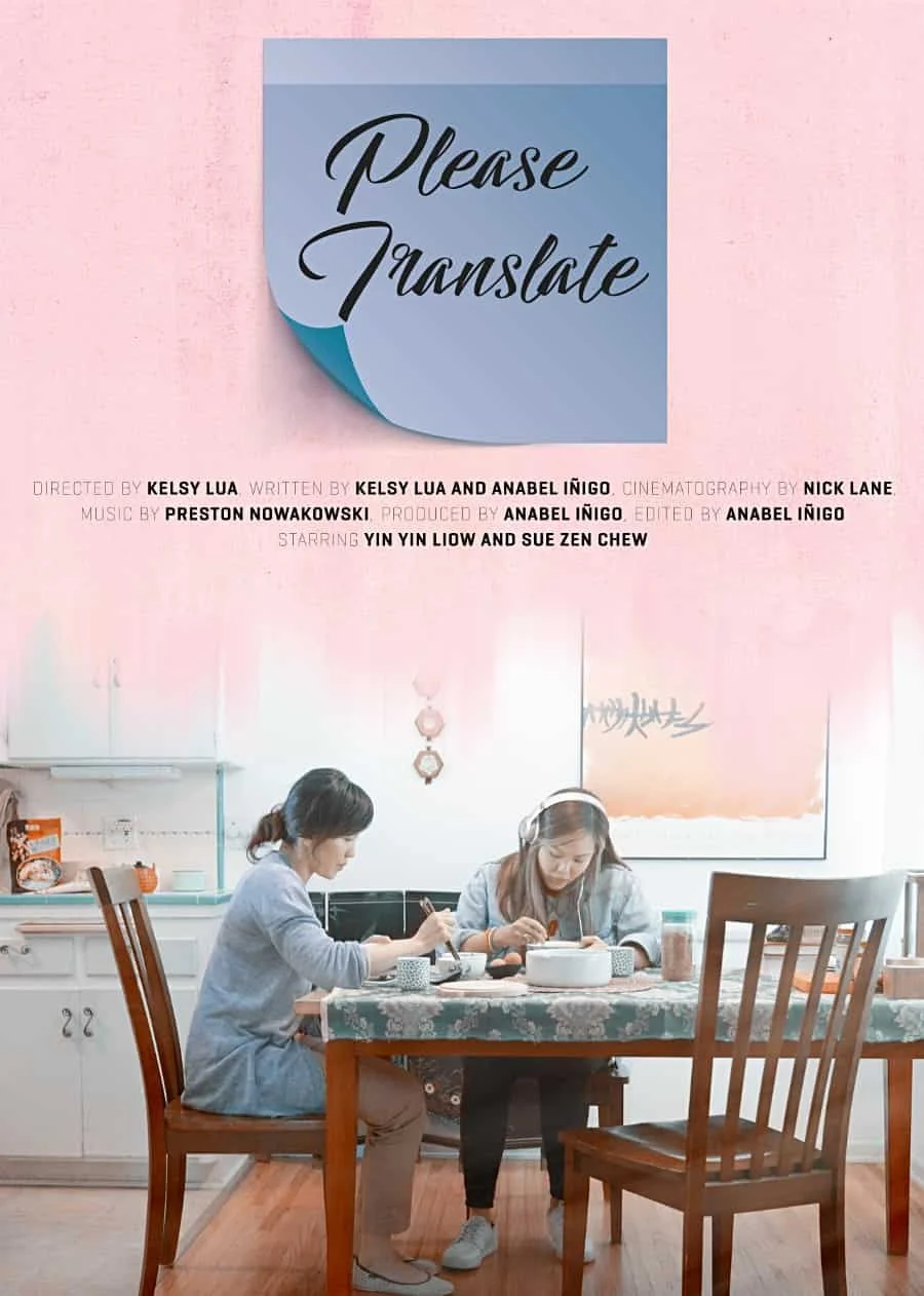 A poster of two women sitting at a dining table doing activities, with a pink wall and a large blue sticky note above them that says, "Please Translate."