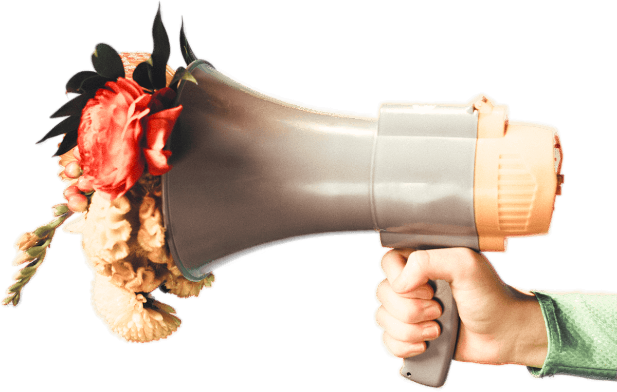 A hand holding a megaphone with an arrangement of flowers emerging from the opening.