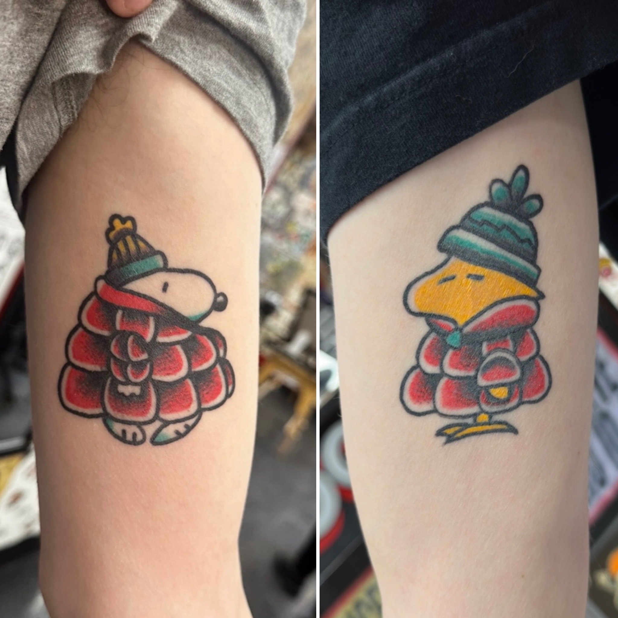 Close-up of two tattooed arms with colorful designs on the skin.