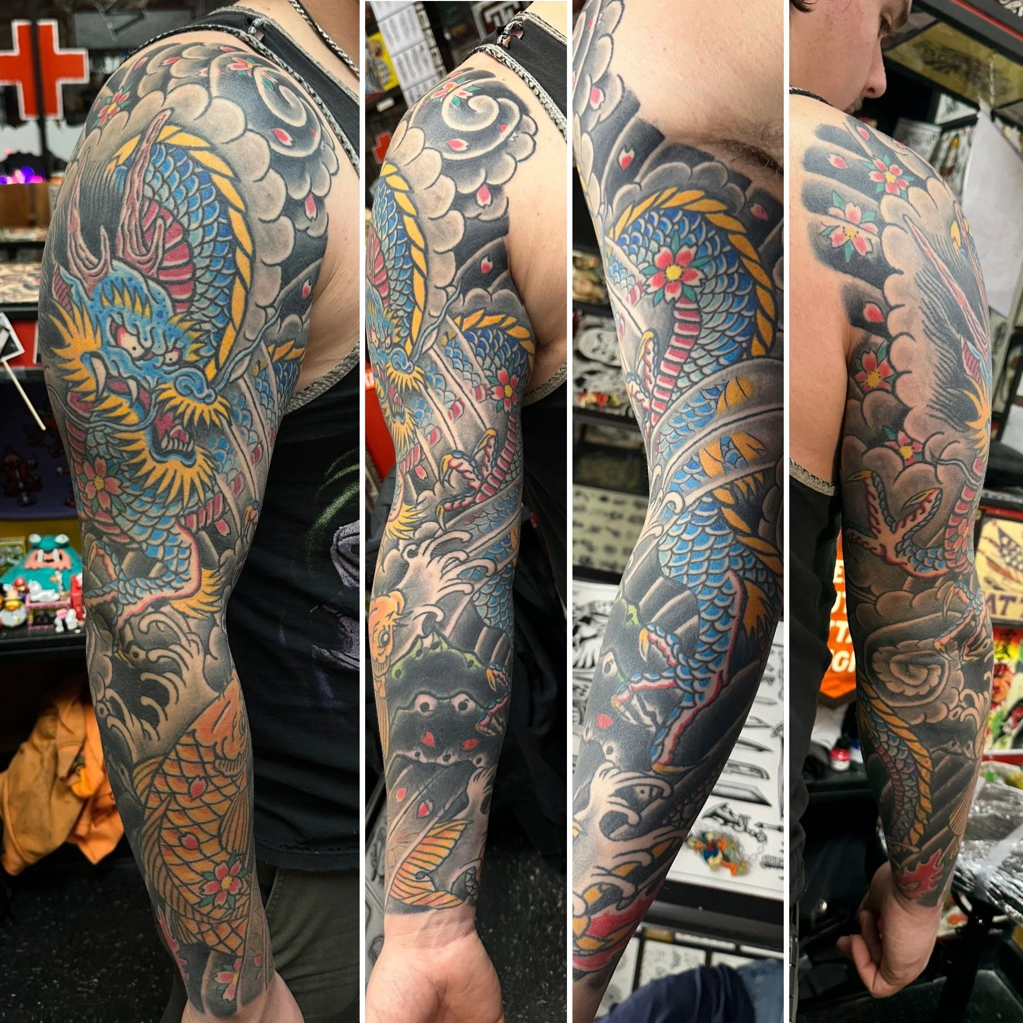 Close-up of a person's arm covered in a colorful Japanese-style dragon tattoo with flowers, clouds, and traditional motifs.