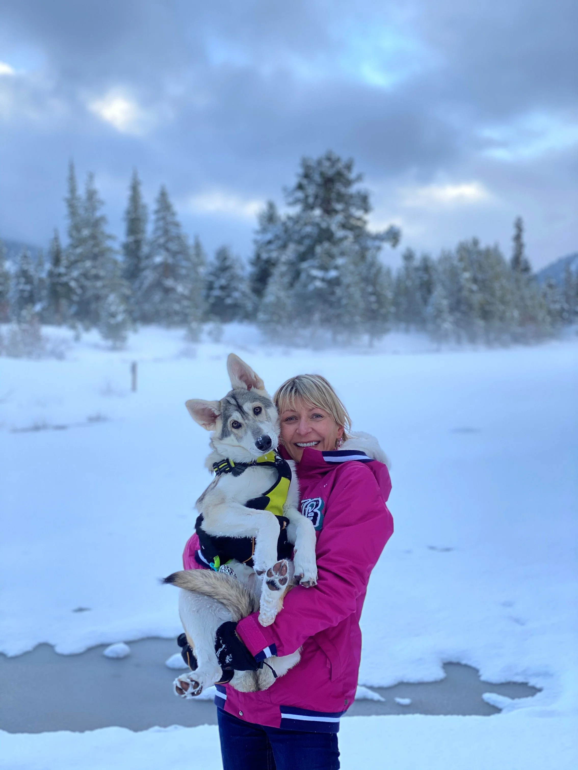 Marta Tuznik holding a northern inuit puppy outdoors in South Lake Tahoe