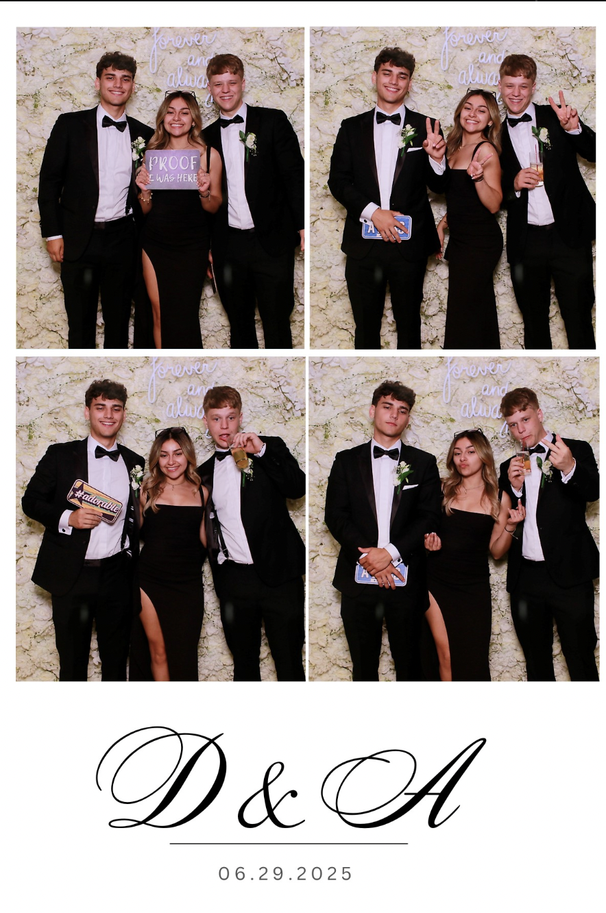 Four couples dressed in formal black tuxedos and dresses, posing in front of a wall with a light-colored floral pattern and a neon sign that reads "forever and always." The couples are making various gestures, holding signs and drinks, celebrating a 