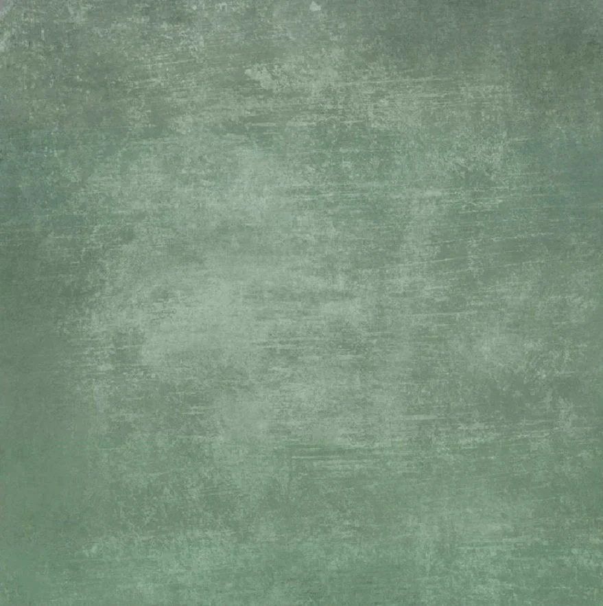 Green textured surface resembling painted or brushed wall or fabric.
