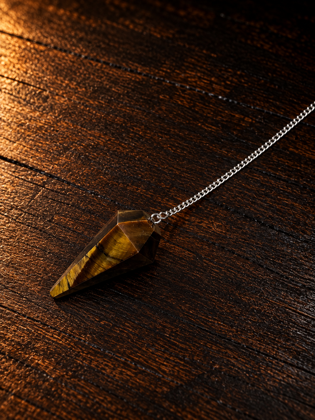 Tiger’s Eye Pendulum on Rustic Wood.png