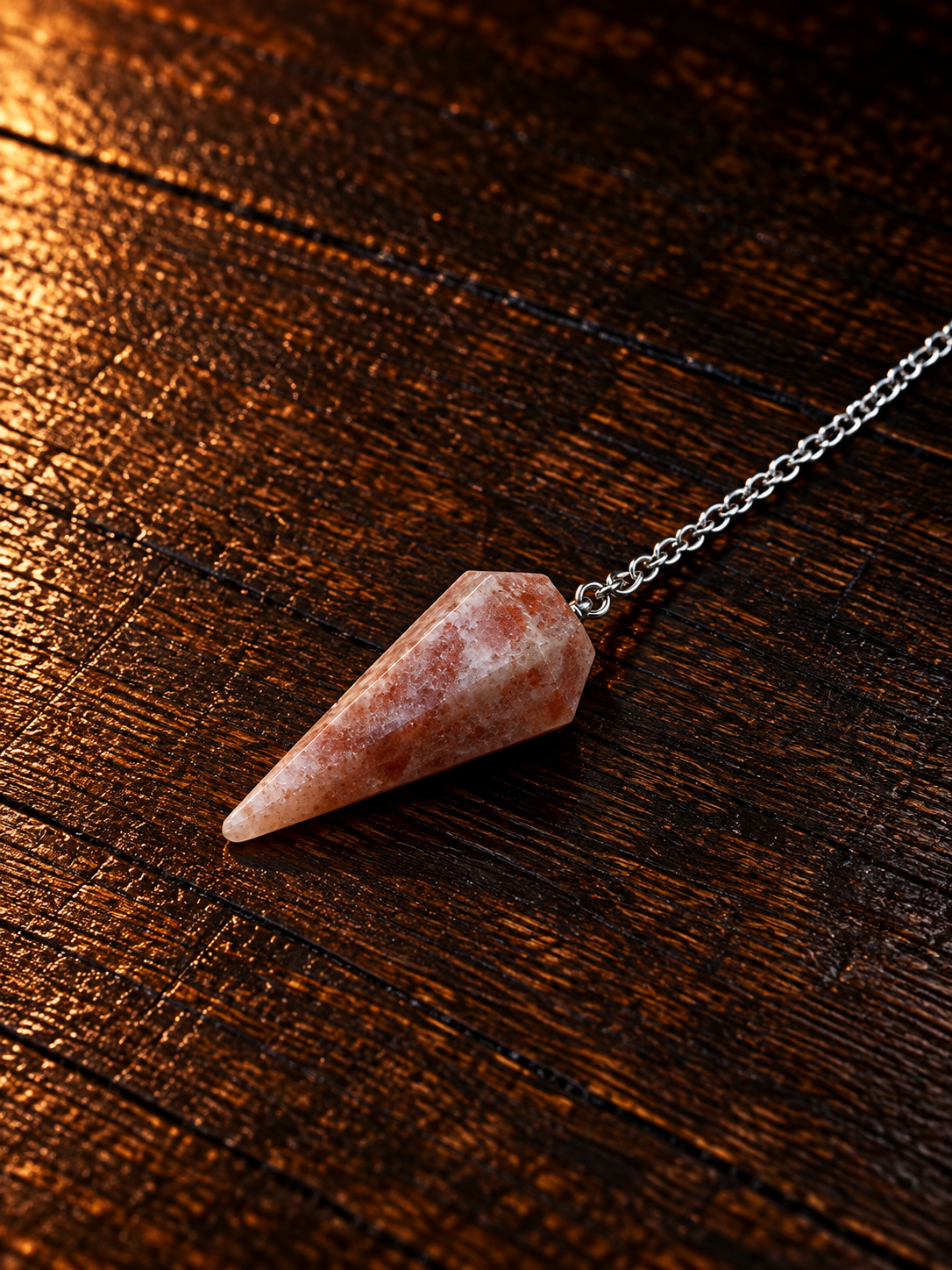 Rose Quartz Pendulum on Rustic Wood.png