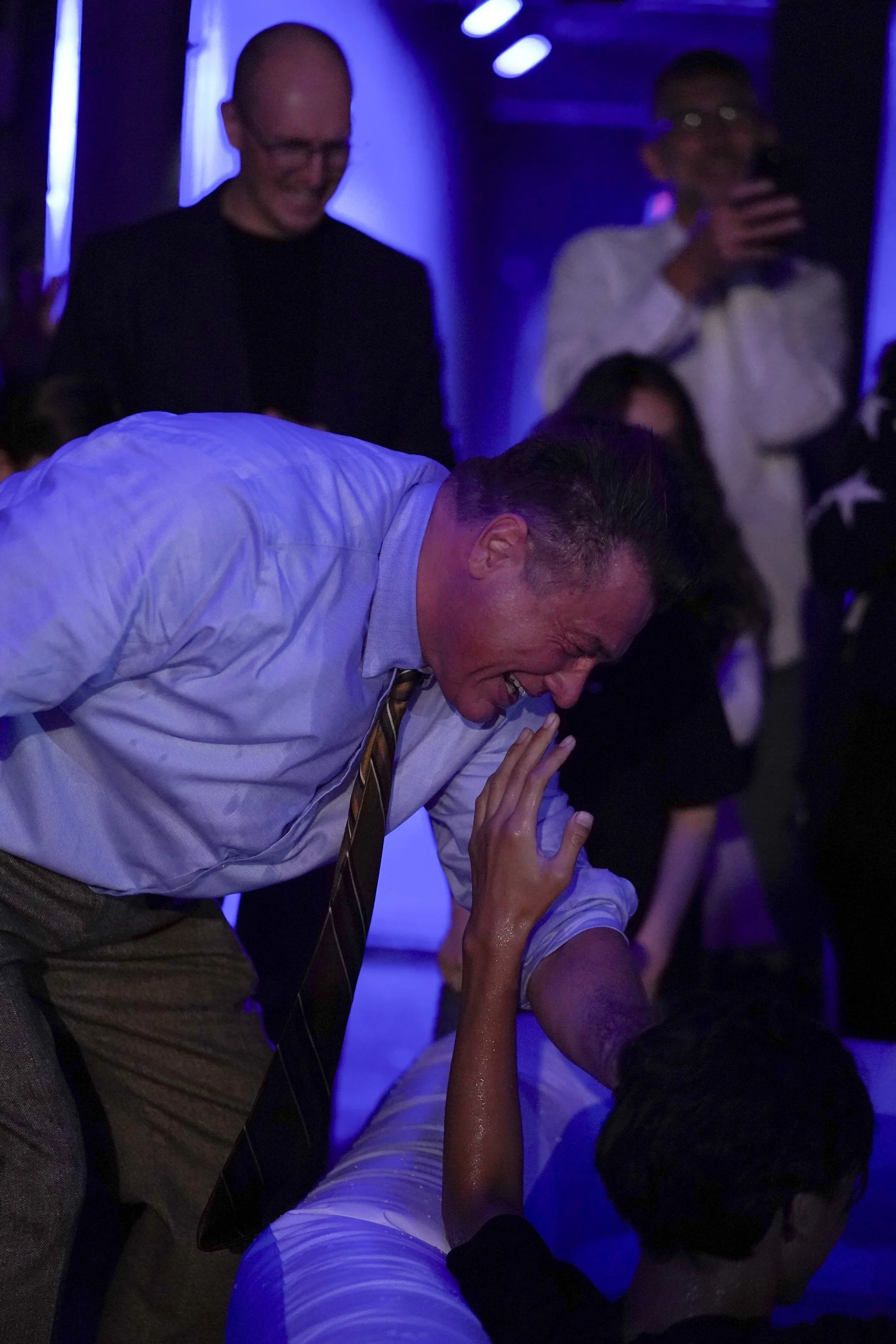 A man is praying over a young boy after a baptism at Acts Church Hollywood