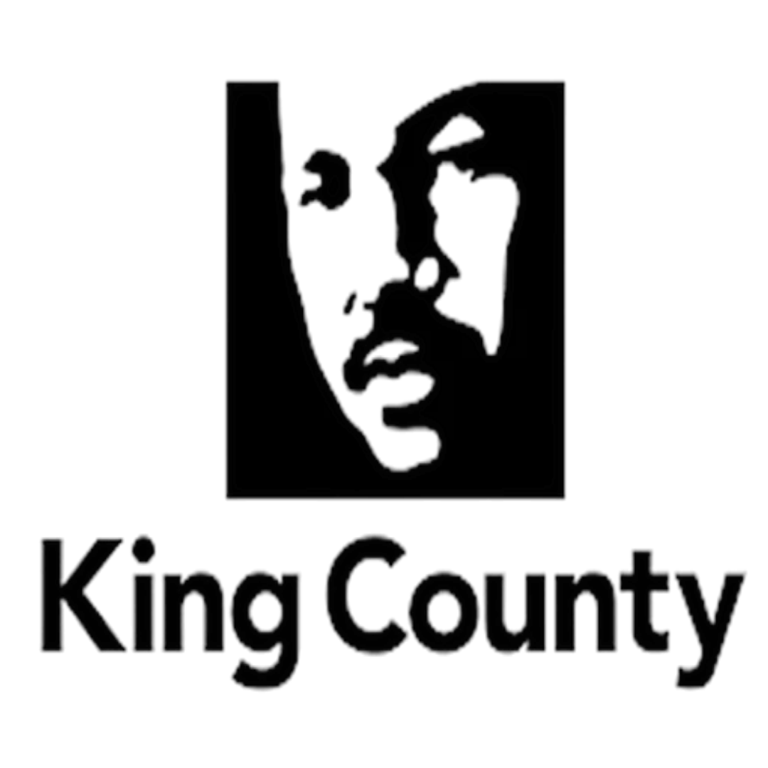 Outline map of King County, Washington, with a face profile within the map and the words 'King County' below.