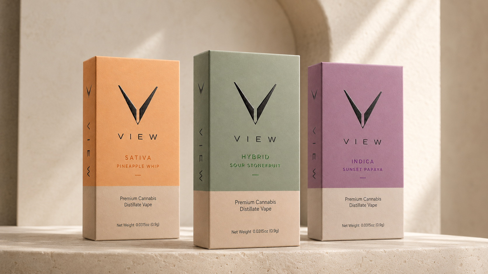 Three boxes of cannabis distillate vape units labeled Sativa Pineapple Whip, Hybrid Sour Stonefruit, and Indica Sunset Papaya, standing on a beige surface with shadows.