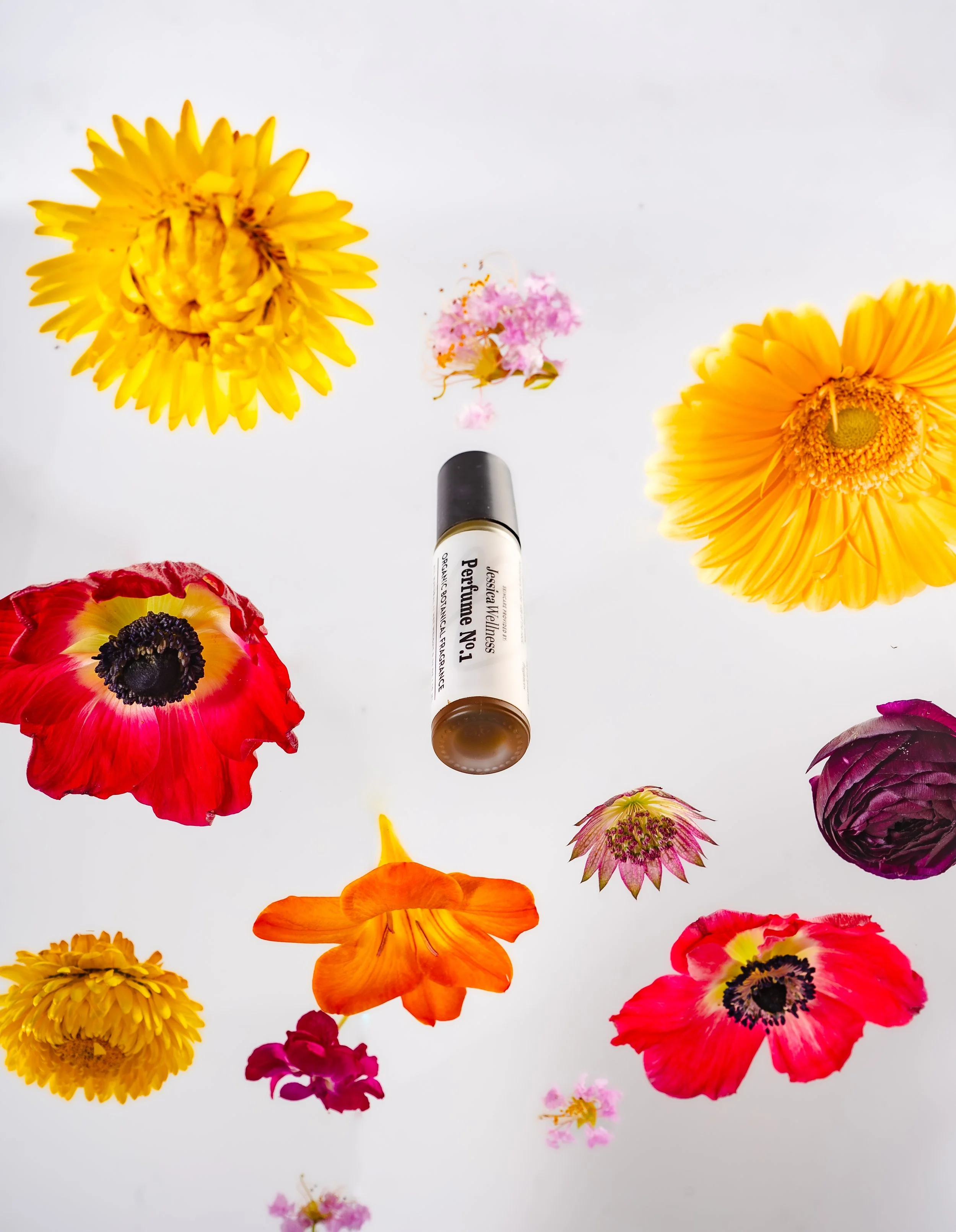 Various colorful flowers and a marker pen on a white background.