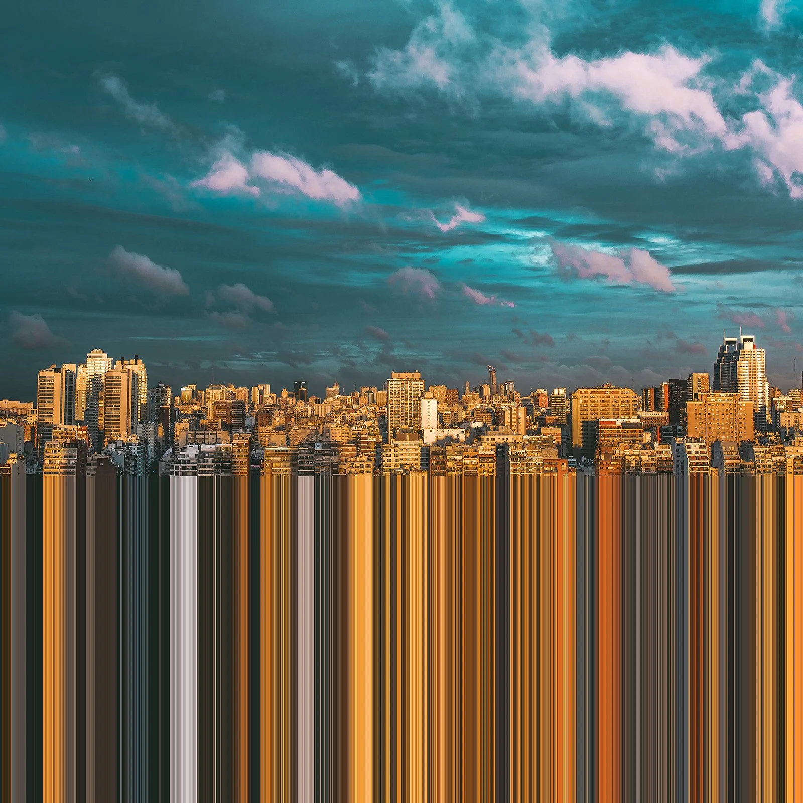 City skyline during sunset with high-rise buildings and a partly cloudy sky.