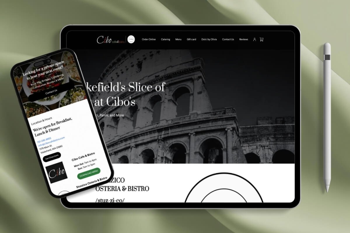 A tablet showing the website of Cibo Osteria & Bistro with a black and white image of the Colosseum. A smartphone displays the restaurant's contact information and menu, and a stylus pen is positioned to the right of the tablet. The devices rest on a pale green surface.