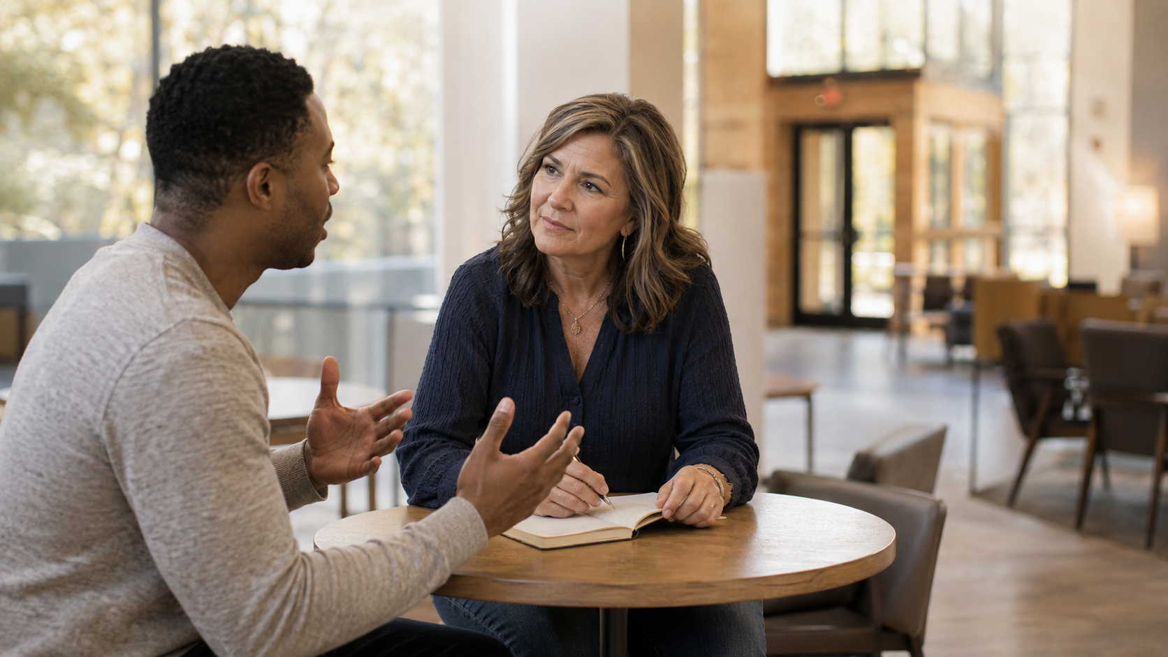 A church consultant guiding a pastor through a leadership strategy coaching session.