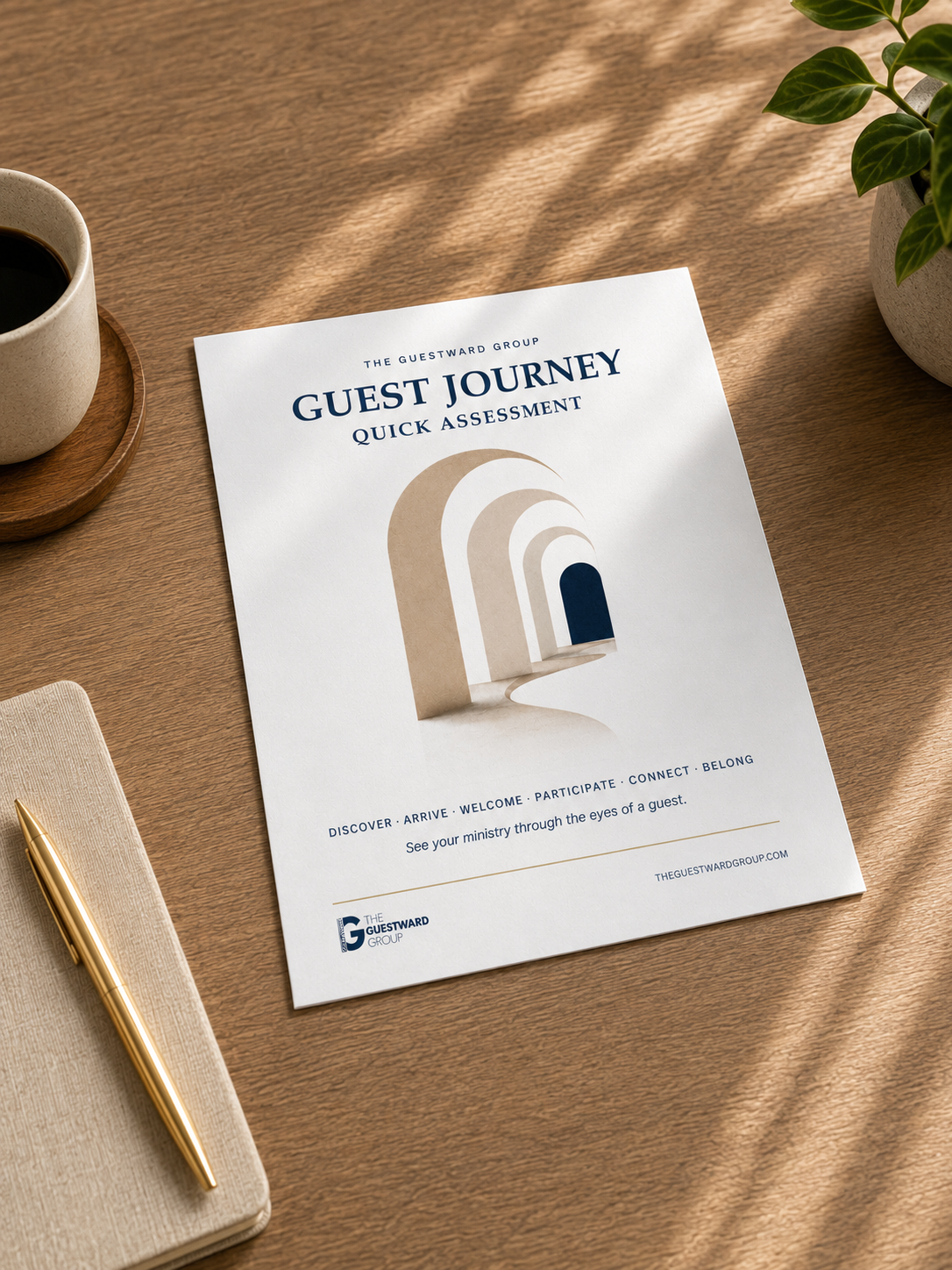 A guest journey quick assessment brochure on a wooden table next to a cup of coffee on a wooden coaster, a beige notebook with a gold pen, and a potted plant.