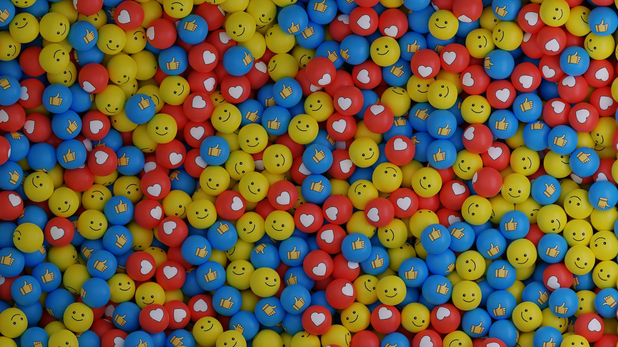 Colorful plastic balls with smiley faces, hearts, and thumbs-up symbols.