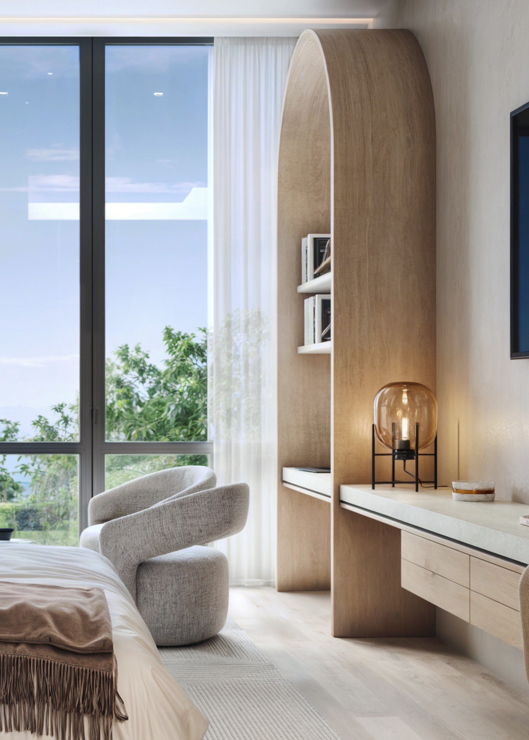A modern bedroom with a large window, a white curtain, gray armchair, wooden arched wall shelf with books, and a white dresser with a decorative lamp, viewed during the daytime.