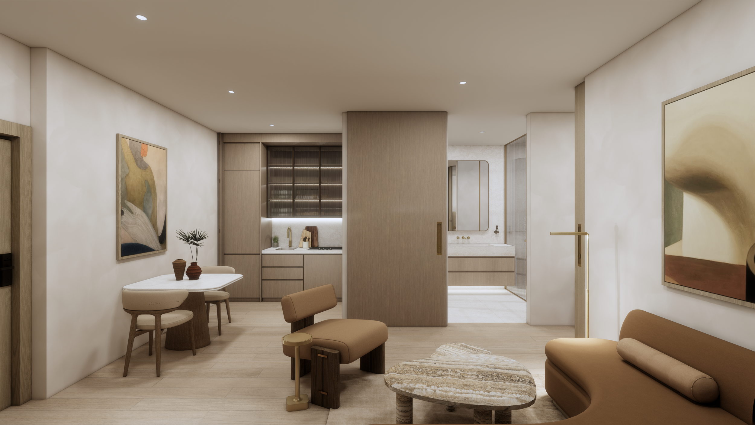 Modern interior of a living space with artwork, a small dining table with chairs, a beige sofa, and a compact kitchen area with wood cabinets and a sink.
