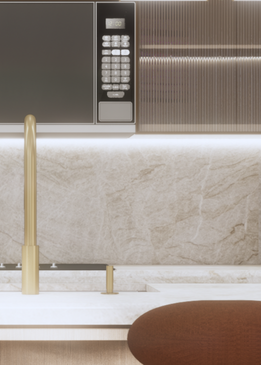 Close-up of a modern kitchen countertop with a gold faucet, microwave, and brown textured cabinet.