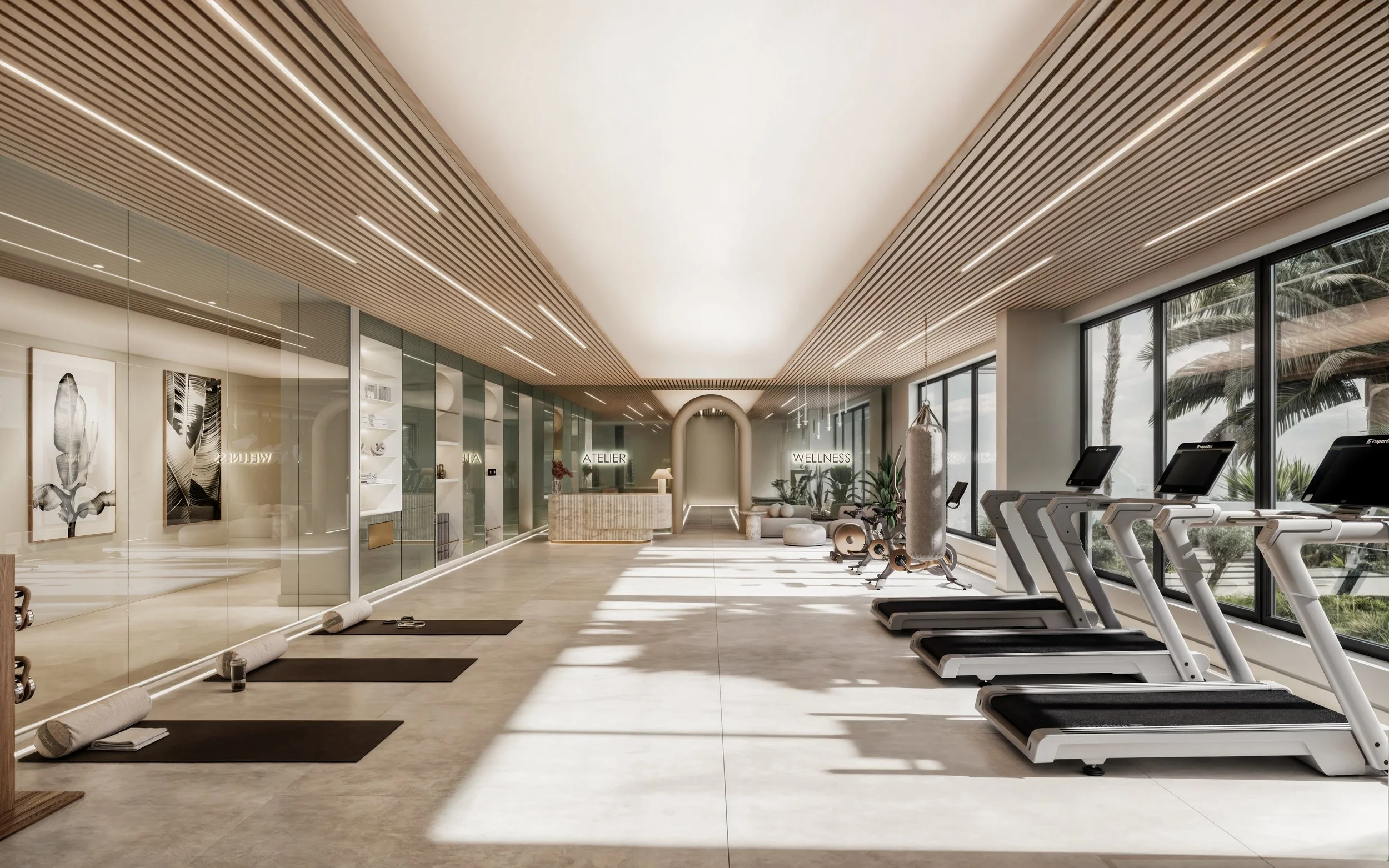 A modern wellness and fitness center with large windows, treadmills, yoga mats, and artistic black and white wall art.
