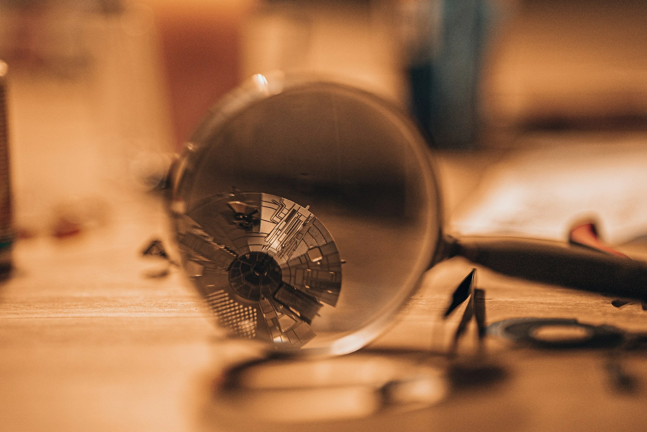 Close-up view down a metallic spiral staircase, viewing from top to bottom, with warm lighting highlighting the structure. A magnifying glass symbolizing financial clarity and tax-ready accounting.