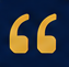 Close-up of a gold quotation mark symbol on a dark background