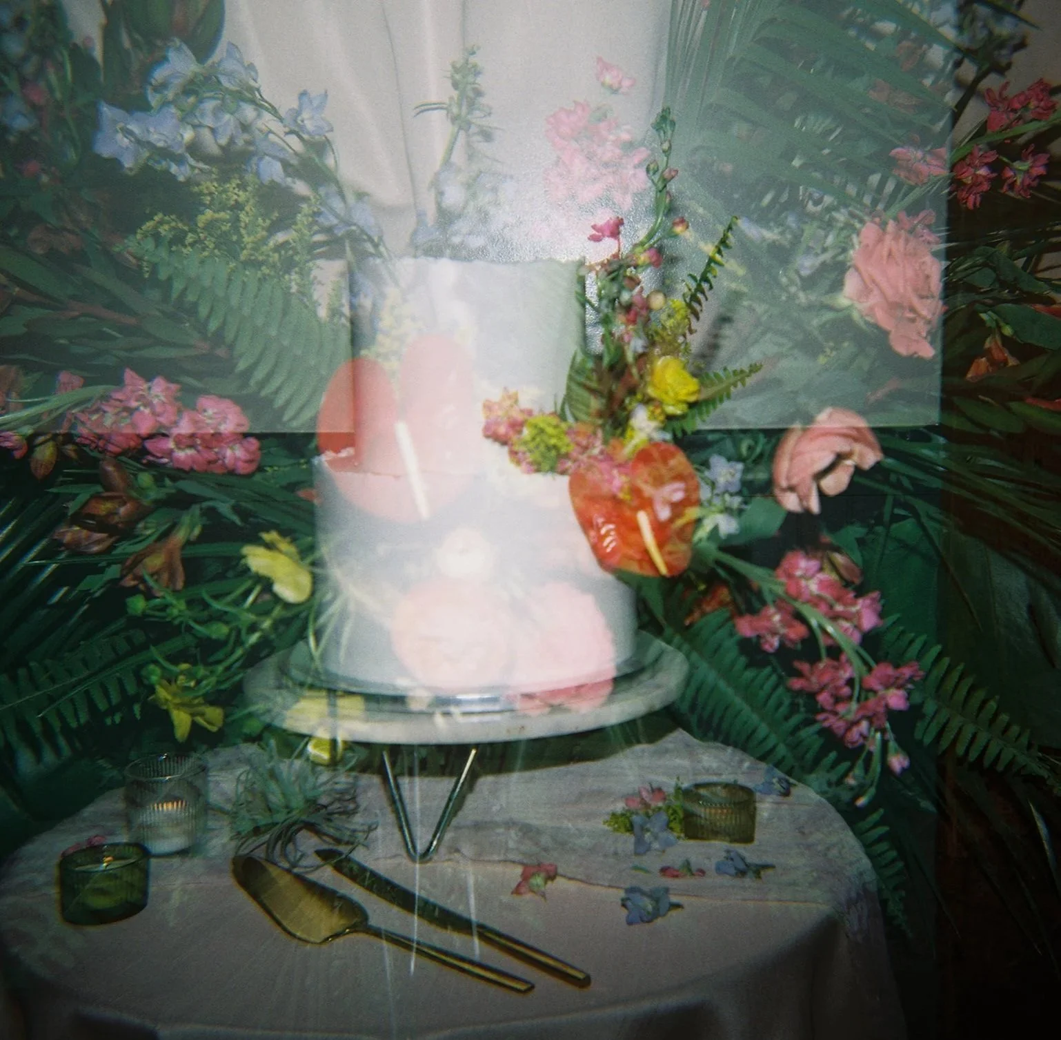 Overlapping images of a floral arrangement with pink and purple flowers and green leaves, a table set with a white tablecloth, a gold spoon, a small glass, and flower petals scattered on the table.