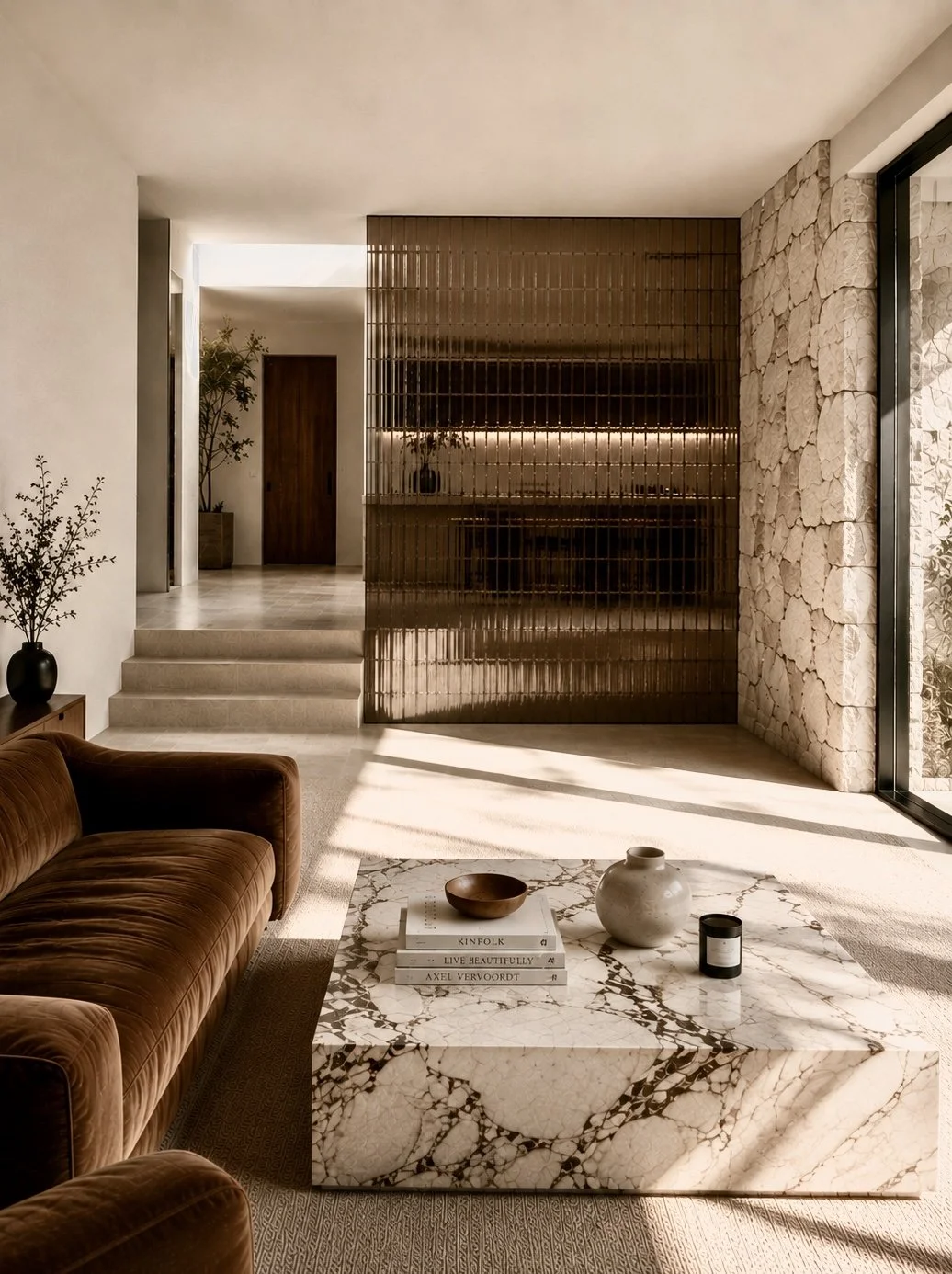 California modern living room interior designed with brown leather seating, natural stone, warm morning light, and timeless residential styling by ACE COMMUNE.